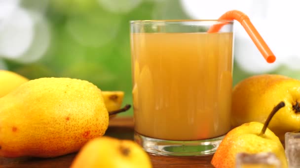 Juice in Glass and Whole and Slice Pear on Table — Stock Video