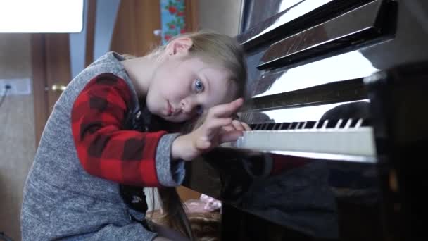 Kind meisje van vijf jaar moe van het leren van piano — Stockvideo