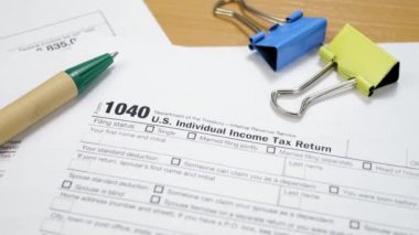 Binder Clips with Pen on 1040 Tax Form