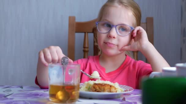 Child Girl Eats at Home Kitchen — Stock Video