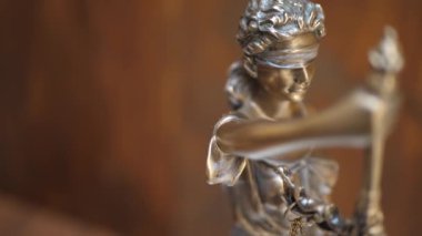 Bronze Statue of Themis or Lady of Justice on Brown Background