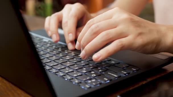 Работница женской компании вводит данные на клавиатуре черного ноутбука — стоковое видео