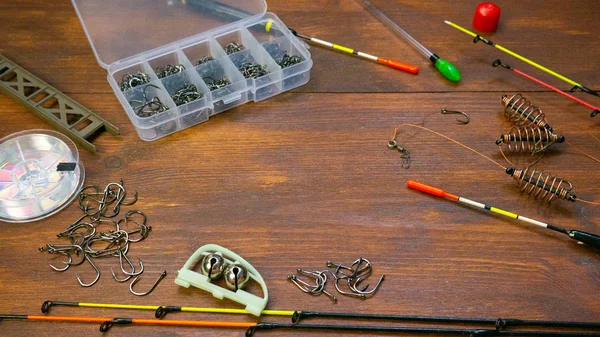 Fishing tackle on wooden brown table background