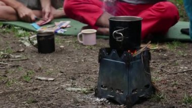 Unrecognized tourists cooks coffee in rest camp