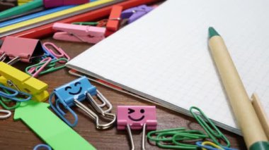 Paper notebook and stationery on wooden brown desk
