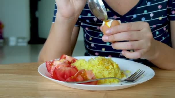 Неузнаваемая женщина ест вареное яйцо — стоковое видео