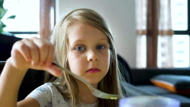 Pretty Caucasian Little Girl Eats at Home — Stock Video