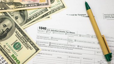 Tax Form and U.S. Dollar Banknotes