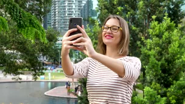 Cute Female Using Smartphone Take Selfie in City Public Park — стокове відео