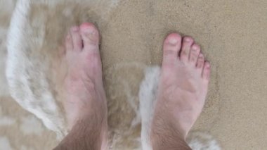 Male Barefoot in Foaming Sea Water Waves