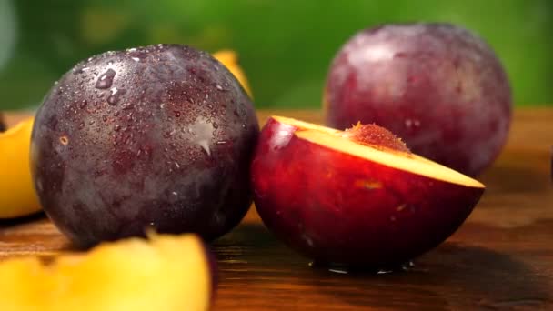 Whole and Cut Slice Plum Fruit on Wooden Brown Surface — Αρχείο Βίντεο