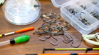 Fishing tackle on wooden brown table background