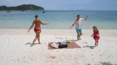 Komik aile deniz kıyısında dans eder, güler ve gülümser.