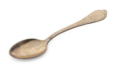 Beyaz bir arka plan üzerinde yalıtılmış bağbozumu altın kaşık