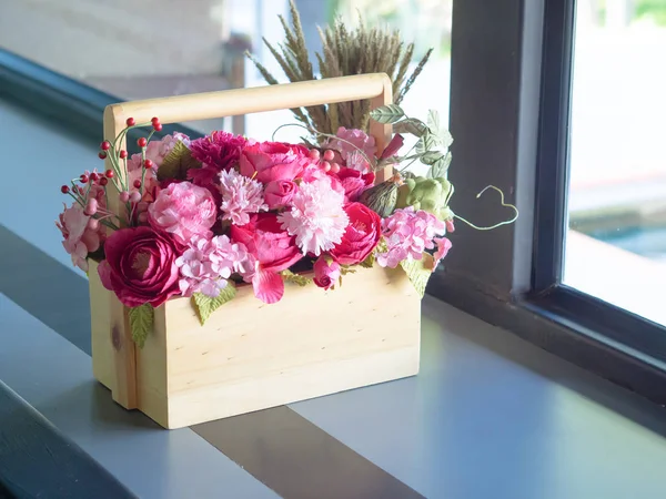 Artificial Flowers in a wooden box. The side windows. — Stock Photo, Image