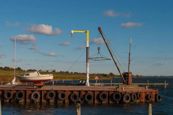 クレーンとデンマークの Bogoe 港の桟橋にボート — ストック写真