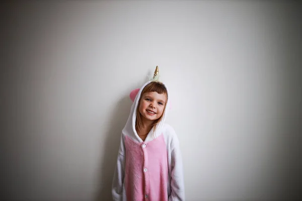 half-body portrait of a todder in unicorn pyjama