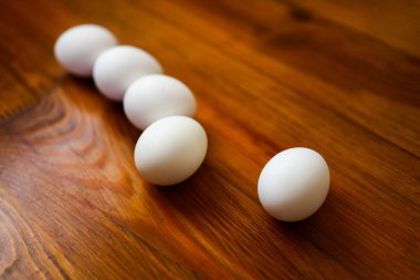 Tahta zeminde beş beyaz yumurta.