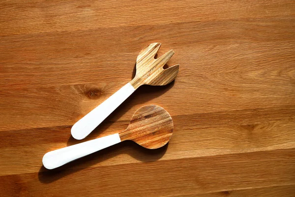 Two different wooden spoons for cooking on wooden table — Stock Photo, Image