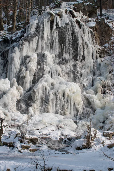 Waterfall with ice in the forest