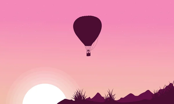 Silhouette of hot air balloon on pink backgrounds