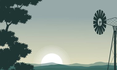 Silhouette yel değirmeni ve ağaç sabahı