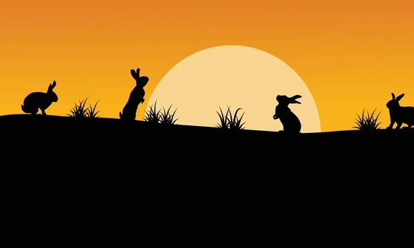 Silhouette de lapin avec ciel orange paysage — Image vectorielle