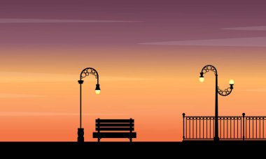 Gün batımı siluetleri sokak lamba ve sandalye manzaraya