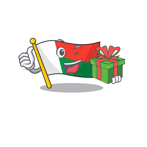 Karikatur auf dem Maskottchen Flagge Madagaskar mit Geschenk — Stockvektor
