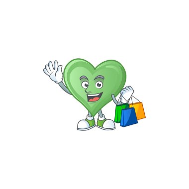Mutlu, yeşil bir aşk el sallıyor ve alışveriş torbasını tutuyor.
