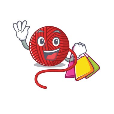 Mutlu bir kırmızı yün yumağı, el sallıyor ve alışveriş torbası tutuyor.