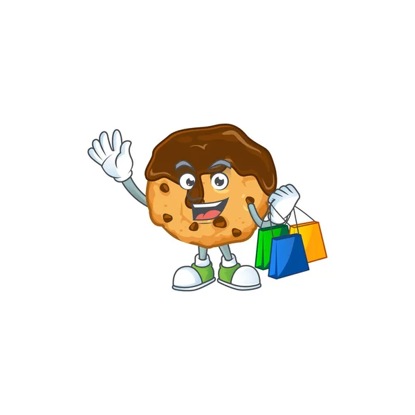 A rich chocolate chips with cream cartoon design waving and holding Shopping bag — Stockvector