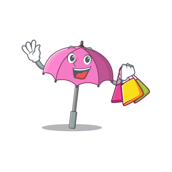 행복 한 풍성 한 분홍색 우산 마스코트 디자인 손을 흔들고 쇼핑백을 들고 있다 — 스톡 벡터