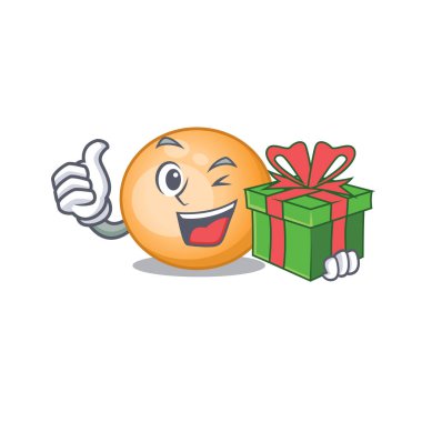 Gülümseyen staphylocuccus aureus çizgi film karakteri yeşil bir hediye kutusu var.