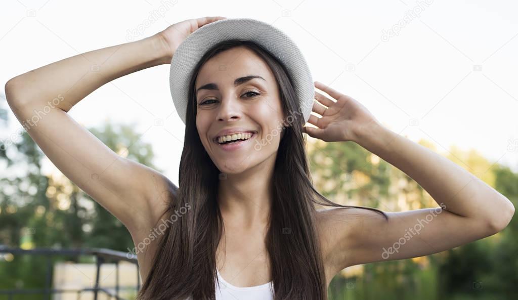 happy woman with raising hands on street 