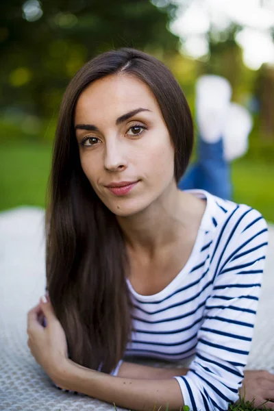 Mujer joven acostada en la hierba — Foto de Stock