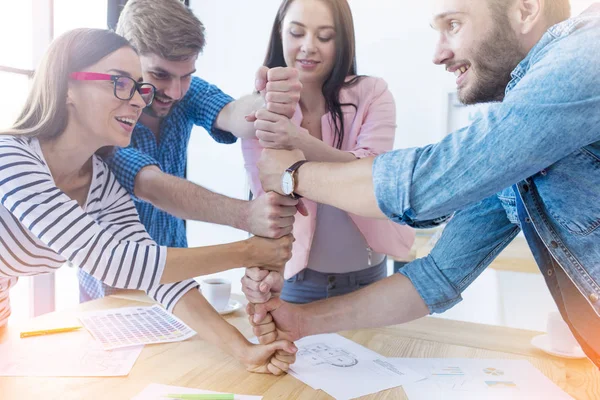 Business people putting fists  together — Stock Photo, Image