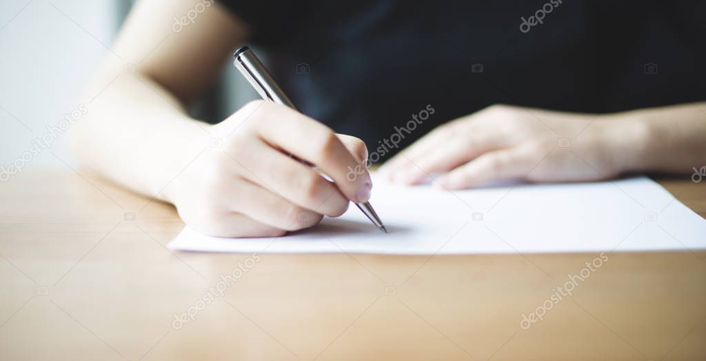 female write something on paper