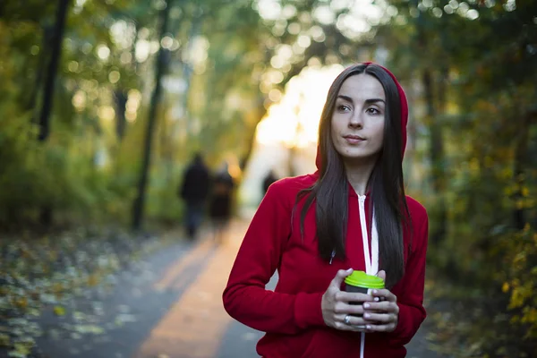 Mulher andando no parque com copo — Fotografia de Stock