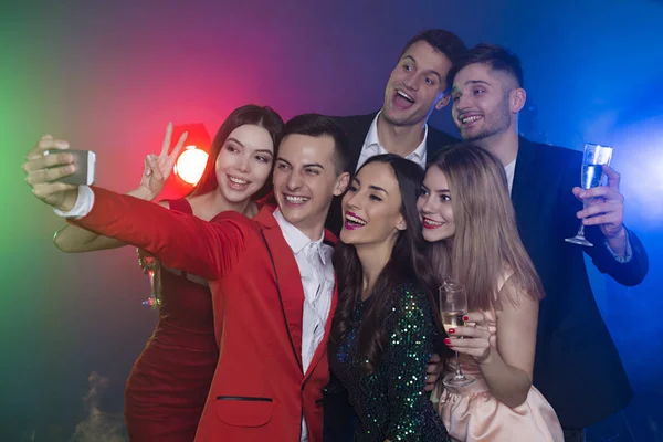 Cool friends. A company of happy friends at the party make a selfie photo with champagne. New Year. Birthday. Christmas.