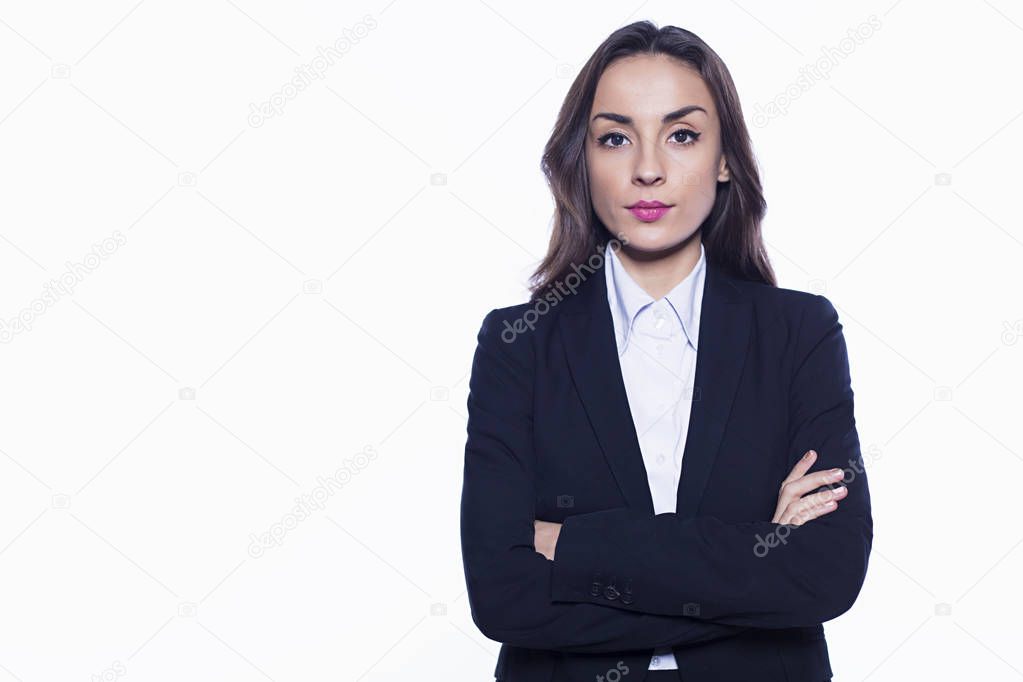 Young smiling confident business woman looking directly into the camera with arms crossed isolated on white background. Concept of office work.