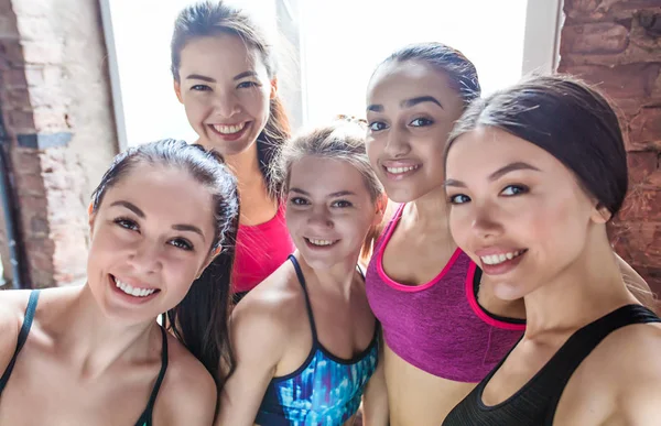 Photo or selfie of sporty women. Group smiling women after training in fitness studio or gym. Fitness, sport concept. Yoga class