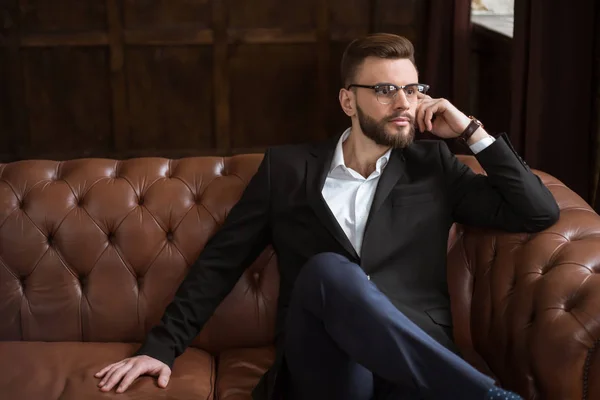 Handsome Stylish Confident Bearded Businessman Smart Suit Glasses Sitting Sofa — Stock Photo, Image