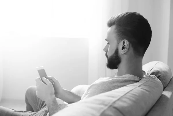man using smart phone black and white photo