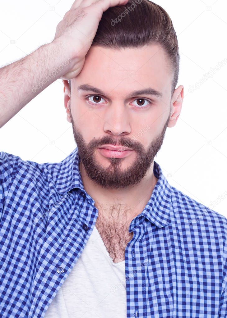 young handsome man posing against white in blue shirt 