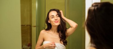 Güzel gülümseyen kadın duş alıyor.