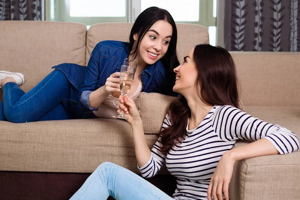 Smiling Beautiful Girl Friends Casual Clothes Talking Drinking Champagne Home — Stock Photo, Image