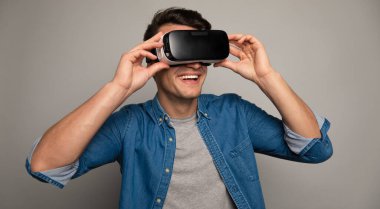 young handsome man wearing vr glasses 