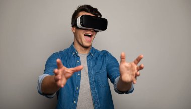 young handsome man wearing vr glasses 