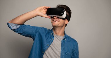 young handsome man wearing vr glasses 